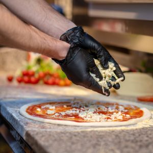 Pizza. Chef baking pizza in the italian pizzeria